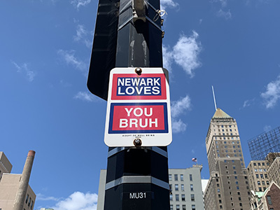 Photo of Newark street sign that reads 'Newark Loves You Bruh'