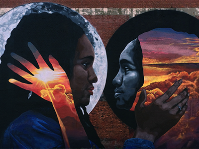 Photo of a public art mural with two young Black people looking into each others' eyes.
